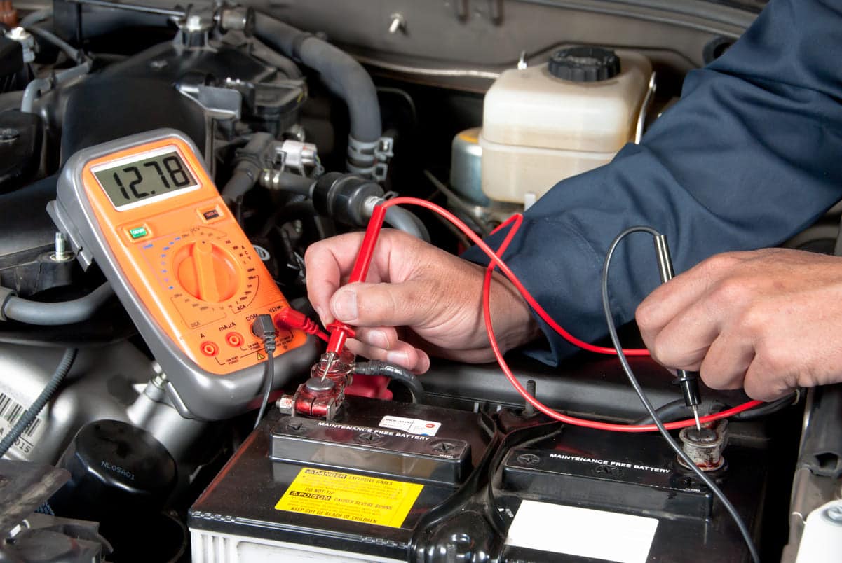 auto mechanic checking car battery voltage 2023 11 27 05 24 11 utc(1)(1)