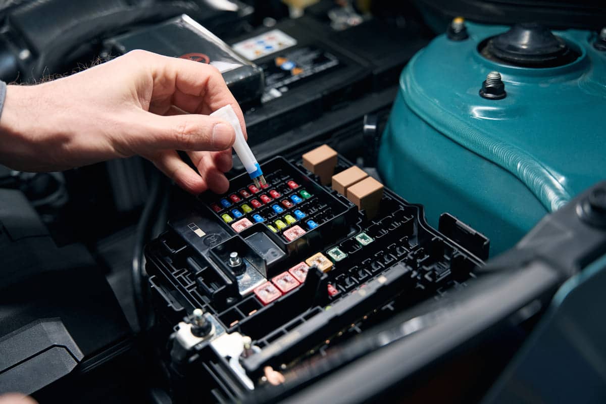 man inspecting technical condition of car fuse 2023 11 27 05 13 11 utc(1)