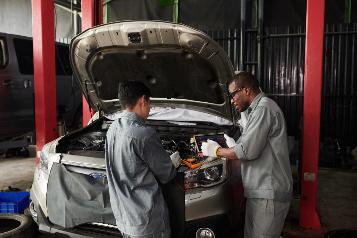 mechanics checking car engine 2023 11 27 05 24 32 utc(1)