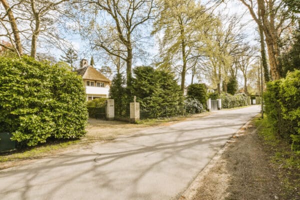 a street with a house and trees and a driveway 2023 11 27 05 32 03 utc(1)