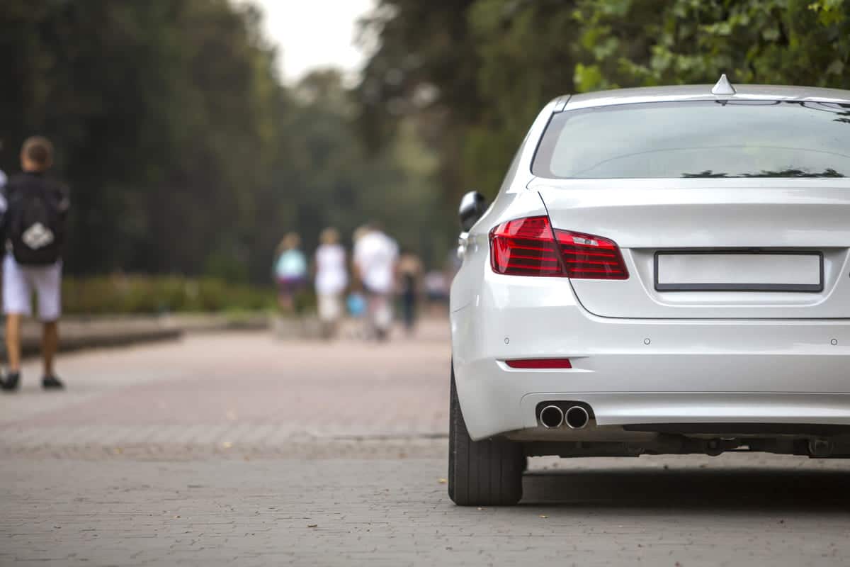 back view part of white car parked on city pedestr 2023 11 27 05 18 53 utc(2)