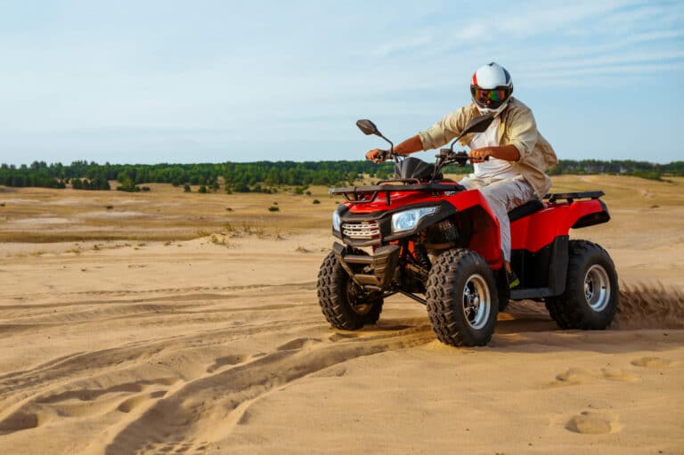 man in helmet rides on atv in desert sands 2023 11 27 05 12 55 utc(2)