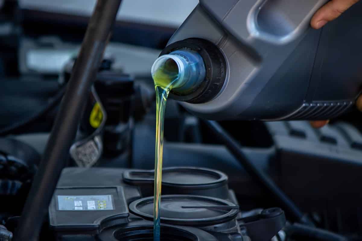 an auto mechanic changing oil pours oil into a car 2023 11 27 05 27 34 utc(1)